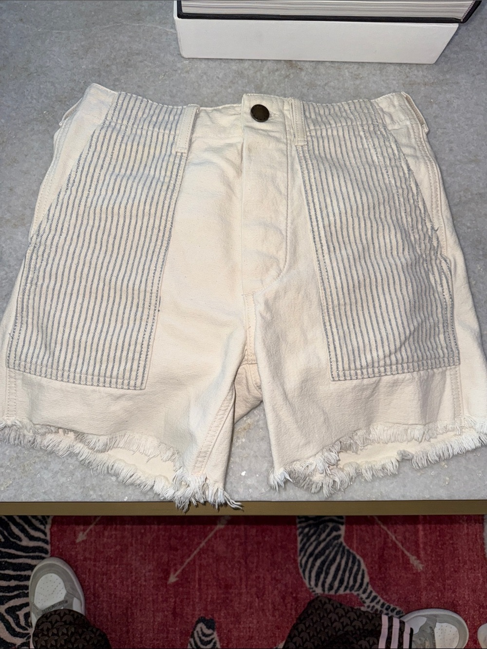 THE GREAT. Cream High-Rise Jean Shorts with Striped Patch Pockets